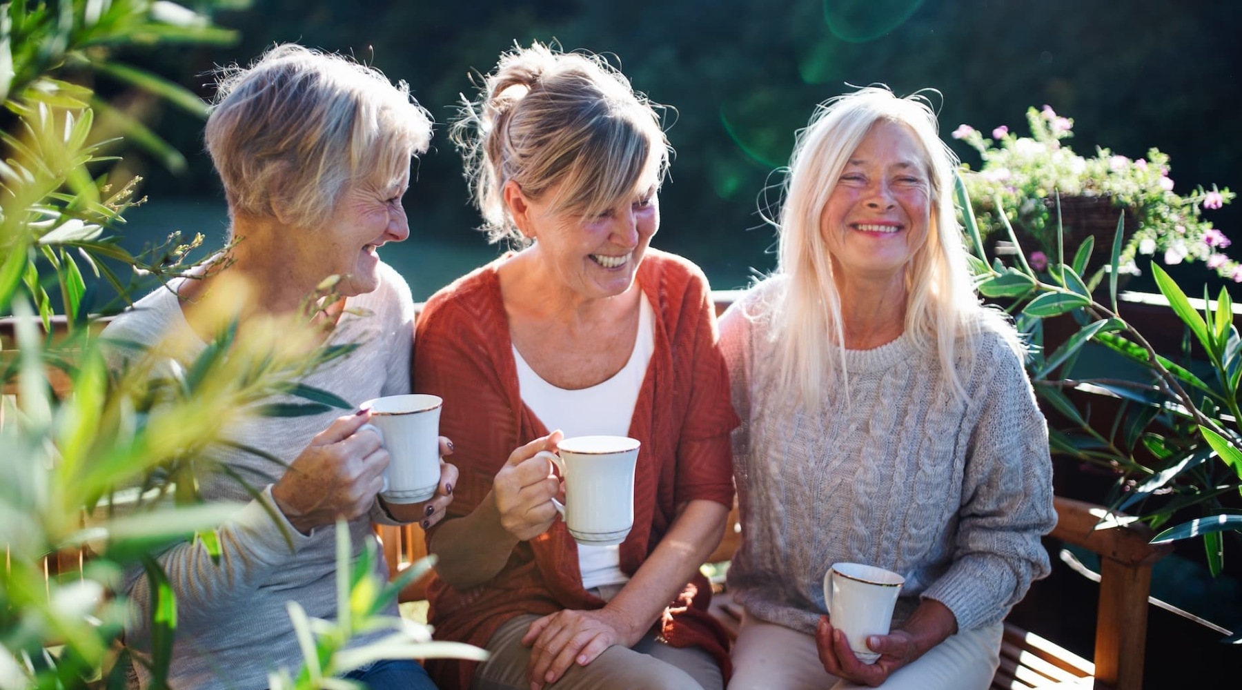 three friends outdoors with drinks