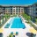 The exterior of The Orchards at Market Plaza senior living community in Plano, TX, featuring a modern facade.