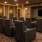 The theater room at our senior living community in Plano, TX, featuring carpeted flooring and chairs in front of a TV.