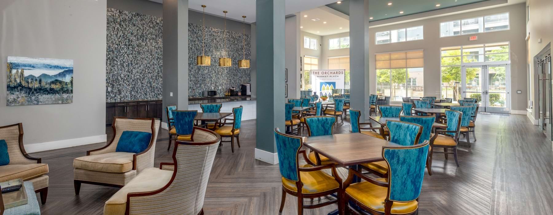 a large area with tall ceilings and chairs to sit in groups