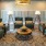 Resident lounge at our senior living community in Plano, TX, featuring a coffee table, chairs, and carpeted flooring.