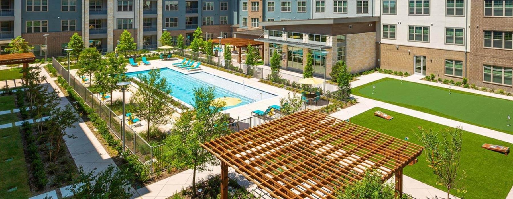 The courtyard and outdoor lounges at our 55 and over apartments in Plano, TX, featuring a luxury pool area.