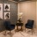 Resident lounge at our senior living community in Plano, TX, featuring cushioned chairs and a small table.